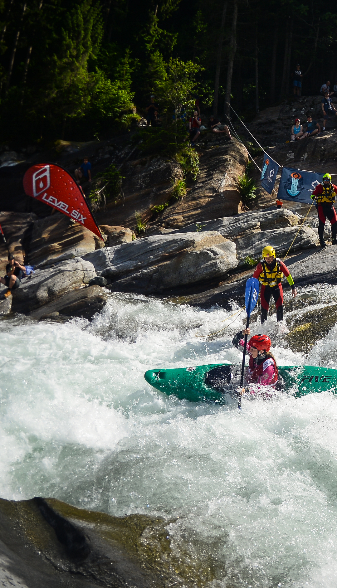 annakayaks King of the Alps extreme kayak championships. Whitewater kayaker girl in a steep rapid.